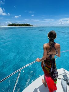 Woman on boat near Taveuni island with bright blue water